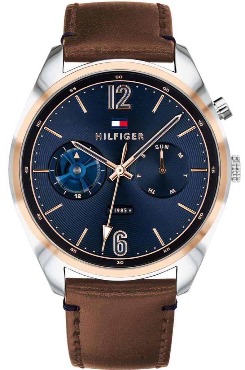 Tommy Hilfiger Deacan watch with blue dial, rose gold case, and brown leather strap