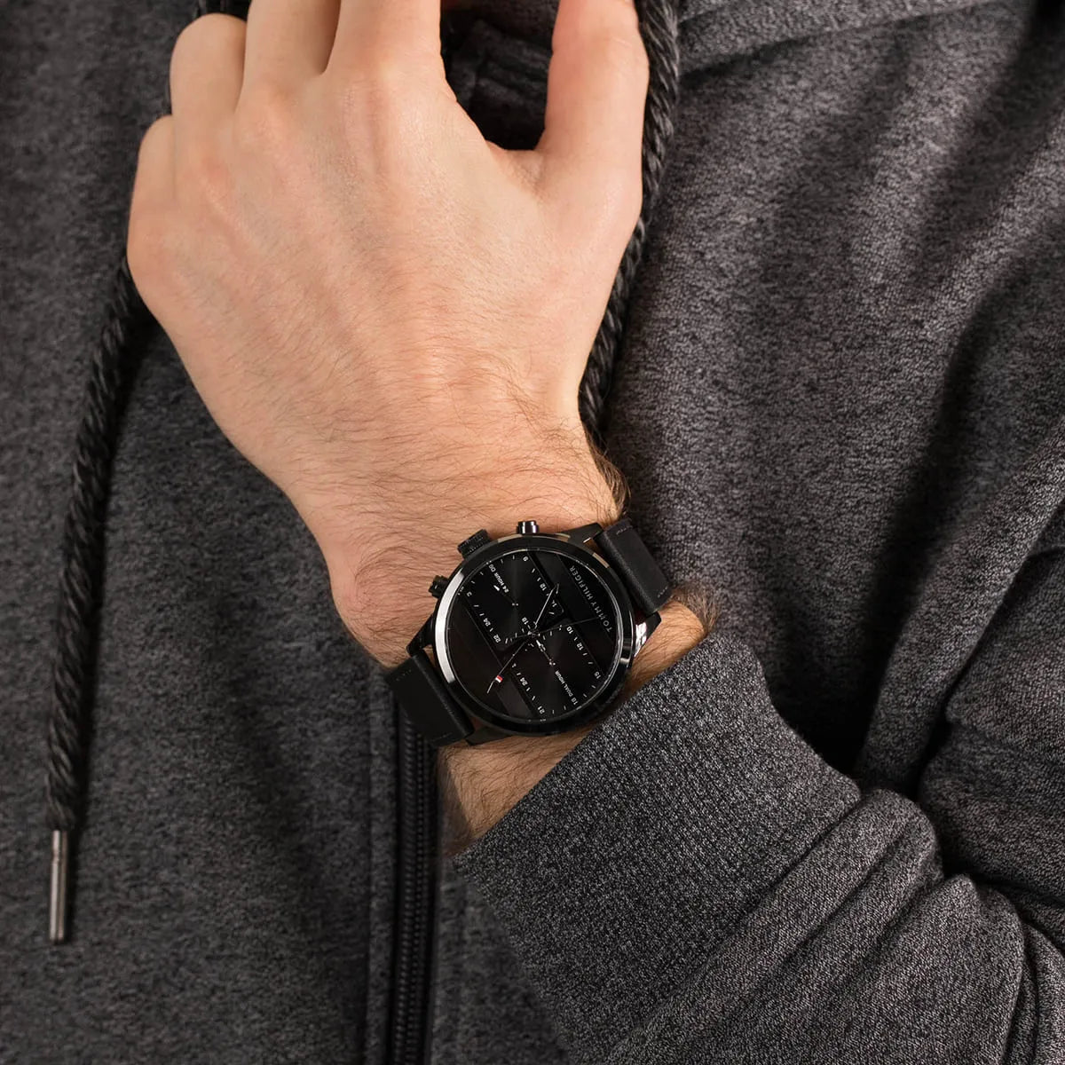 Tommy Hilfiger black dial watch on wrist demonstrating fit and styling