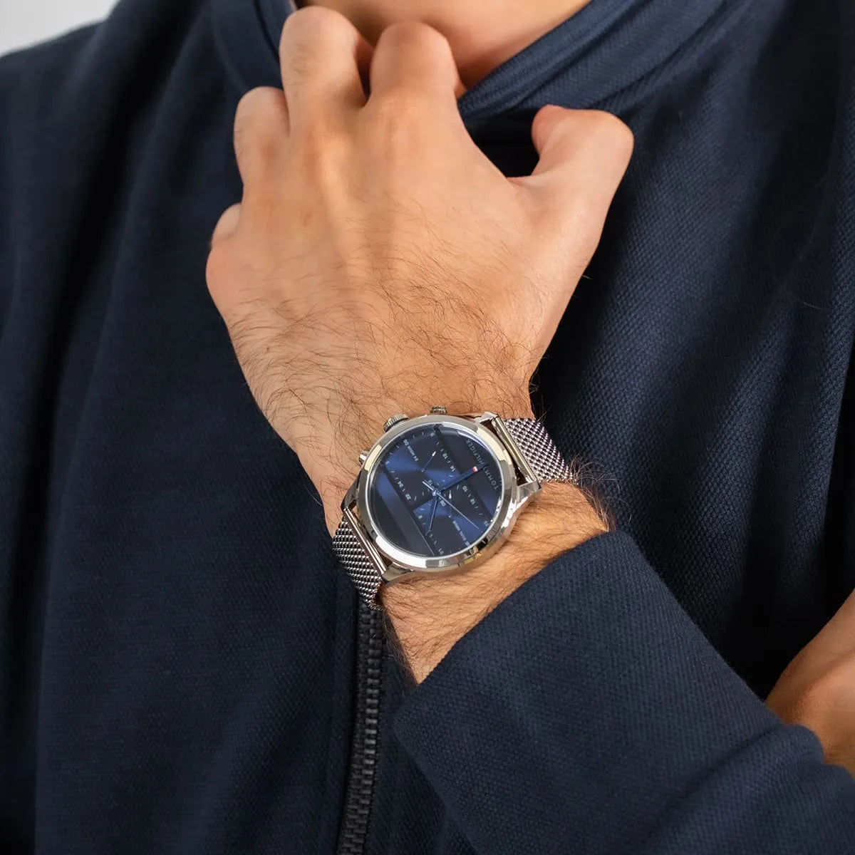 Tommy Hilfiger 1791596 quartz watch on wrist with navy shirt