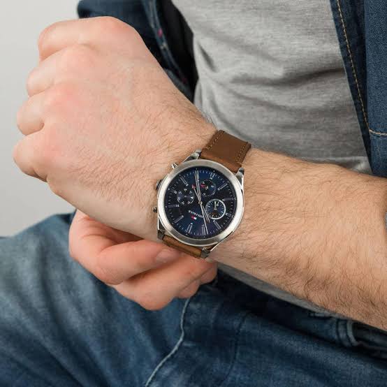 Tommy Hilfiger Ashton chronograph watch on wrist showing navy dial and brown leather strap