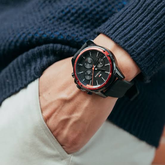 Tommy Hilfiger Mason watch worn on wrist with black strap and red bezel accent