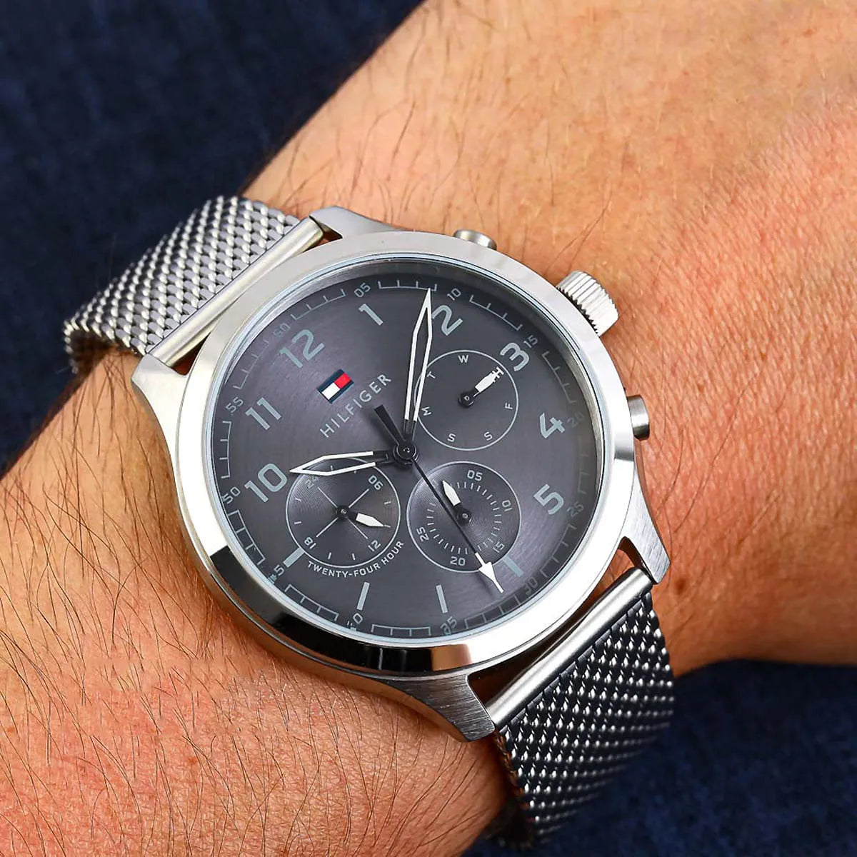 Tommy Hilfiger Asher chronograph watch worn on wrist showing grey dial and mesh band
