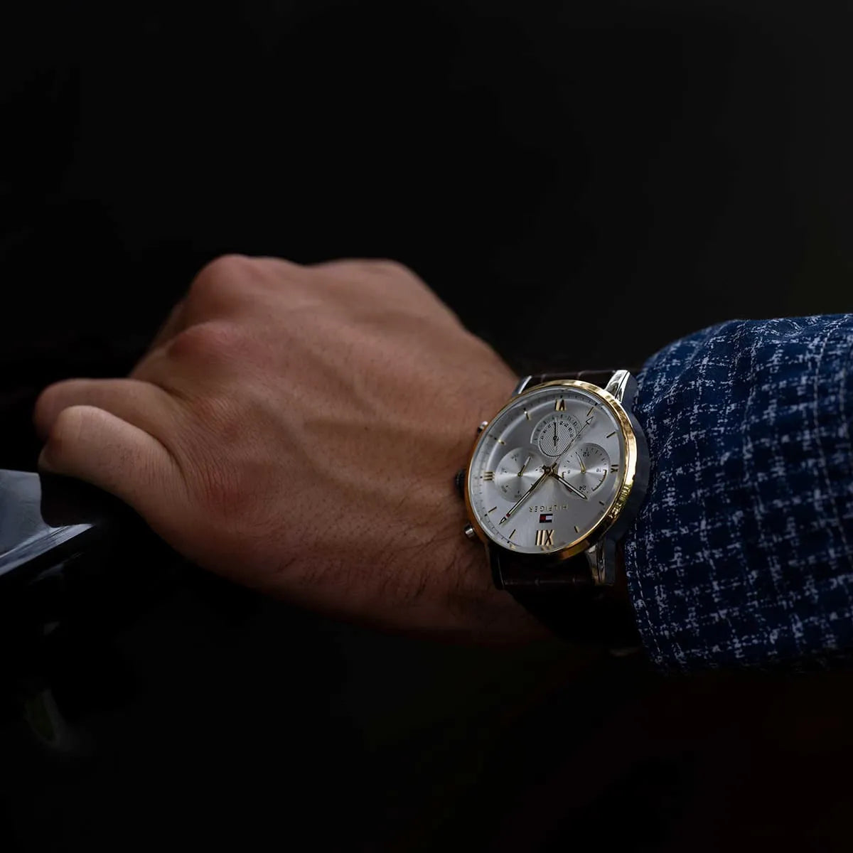Tommy Hilfiger Sullivan chronograph watch on wrist with navy jacket cuff
