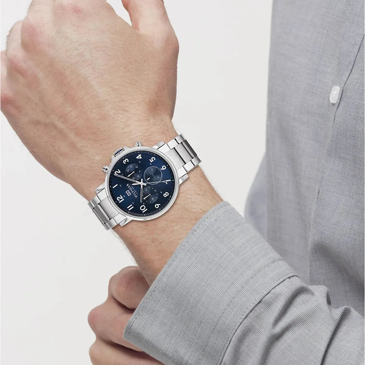 Tommy Hilfiger 44mm blue dial chronograph watch worn on men's wrist with silver bracelet