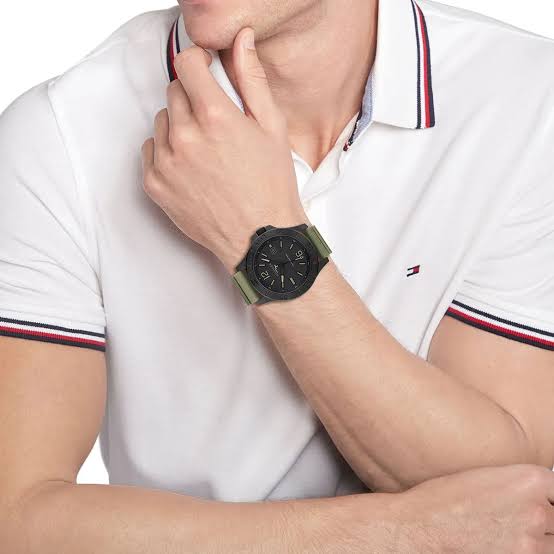 Tommy Hilfiger Ryan watch worn on wrist with black dial and green silicone strap