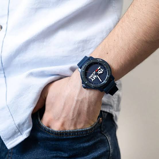 Tommy Hilfiger Jeans Tokyo watch worn on wrist with blue strap against light colored sleeve
