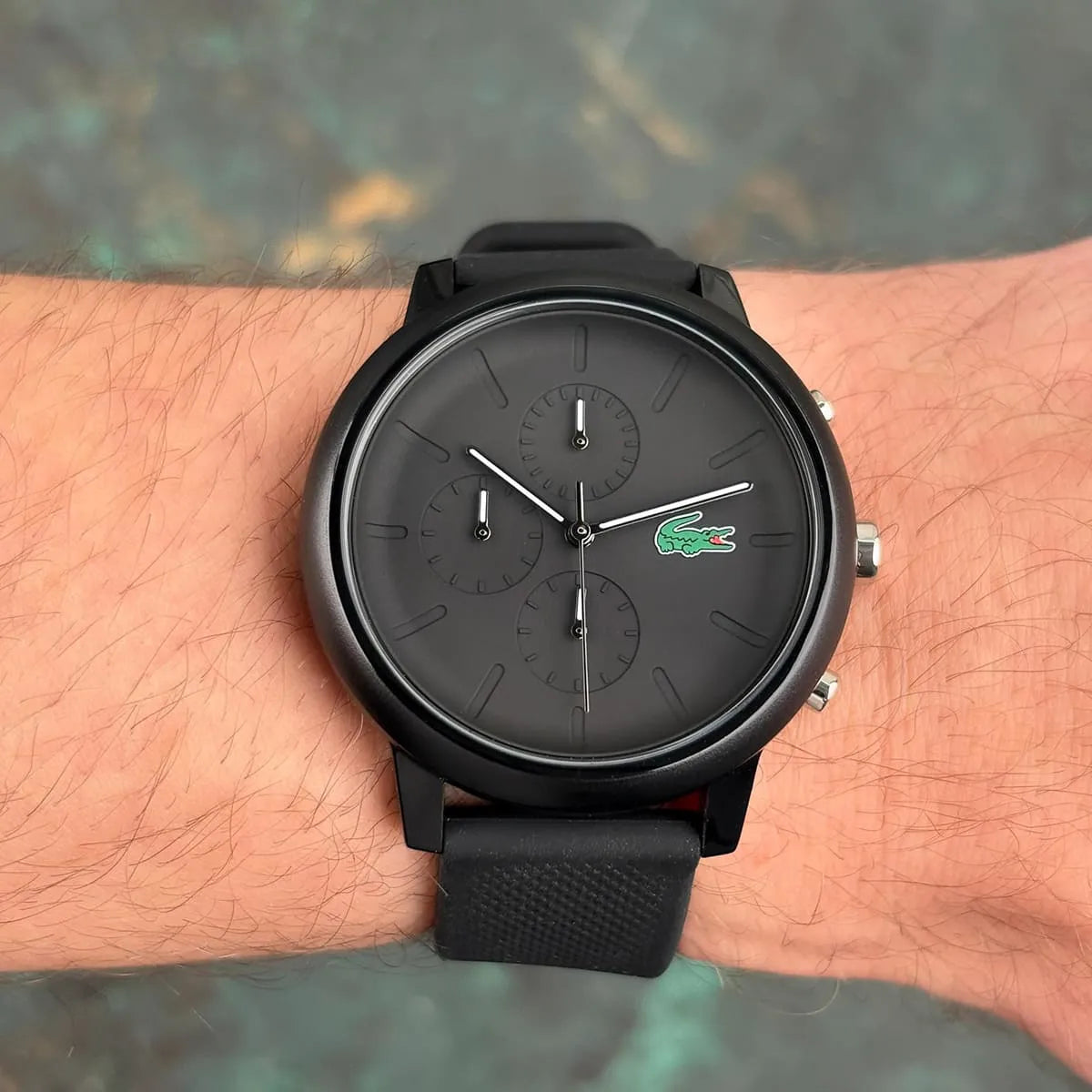 Lacoste 12.12 black chronograph watch worn on wrist