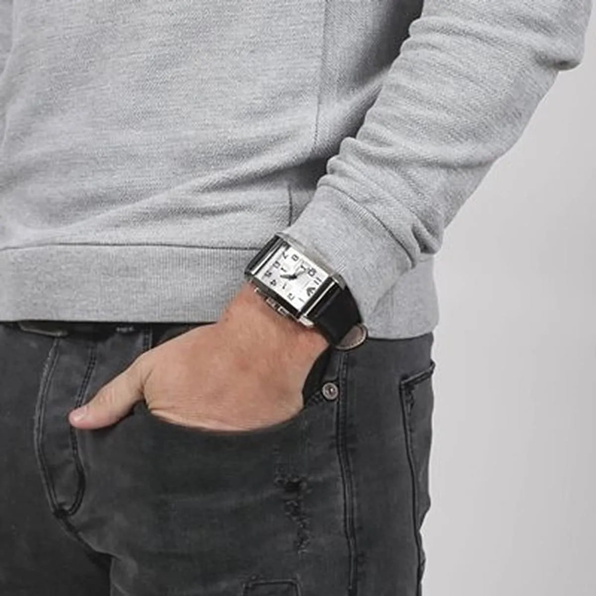 Emporio Armani Marco men's watch worn on wrist with rectangular silver dial and black strap