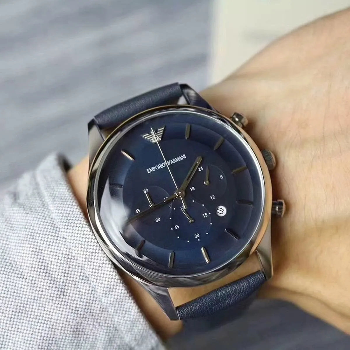 Emporio Armani AR11018 chronograph watch worn on wrist showing blue dial and leather strap
