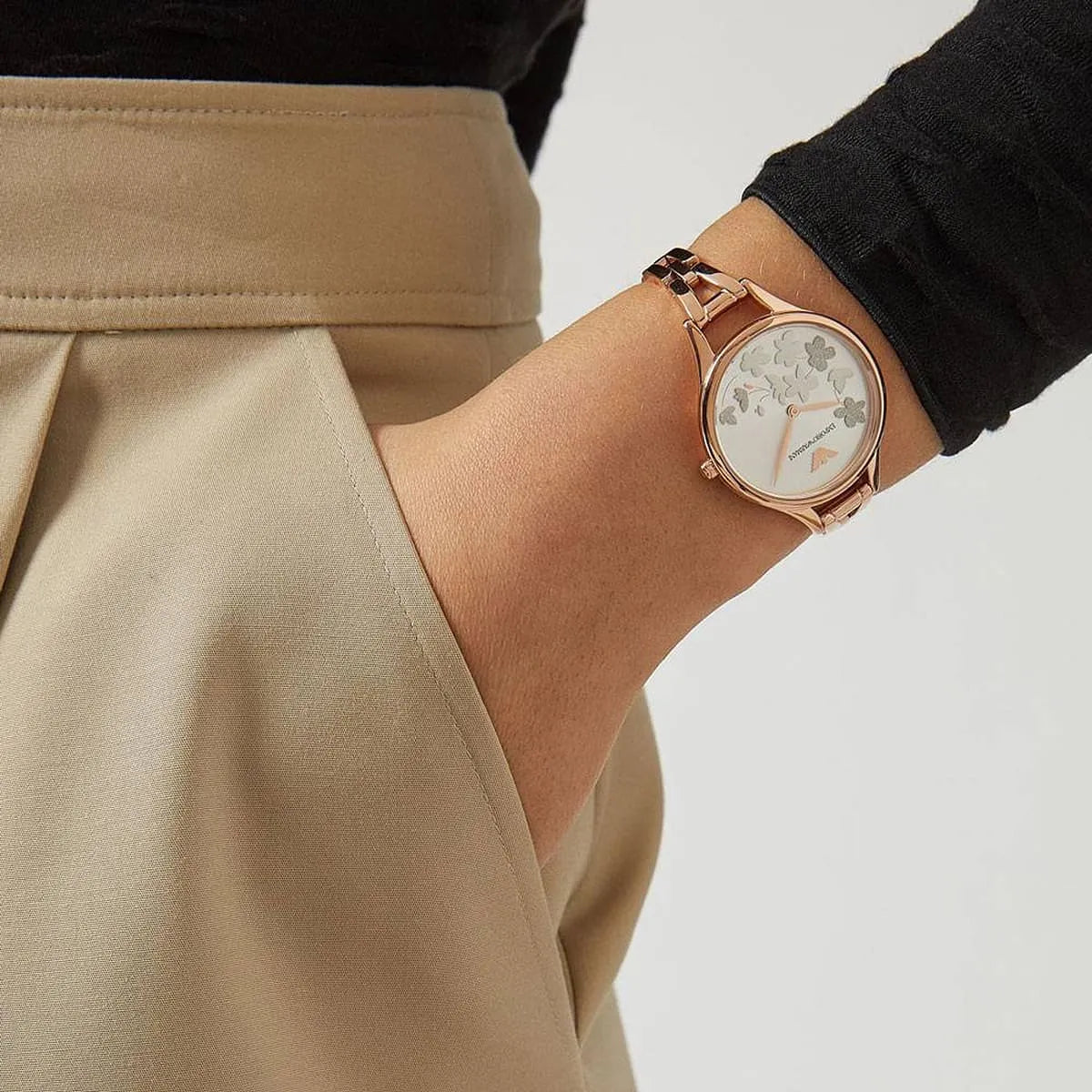 Emporio Armani Aurora rose gold women's watch worn on wrist with casual styling
