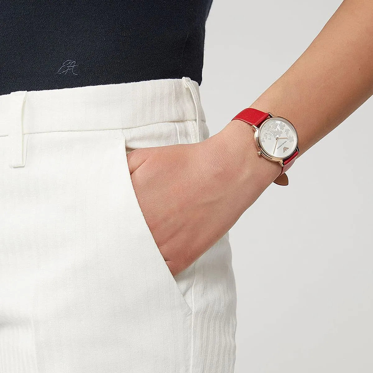 Emporio Armani Kappa AR11114 on wrist paired with white outfit, red leather strap visible