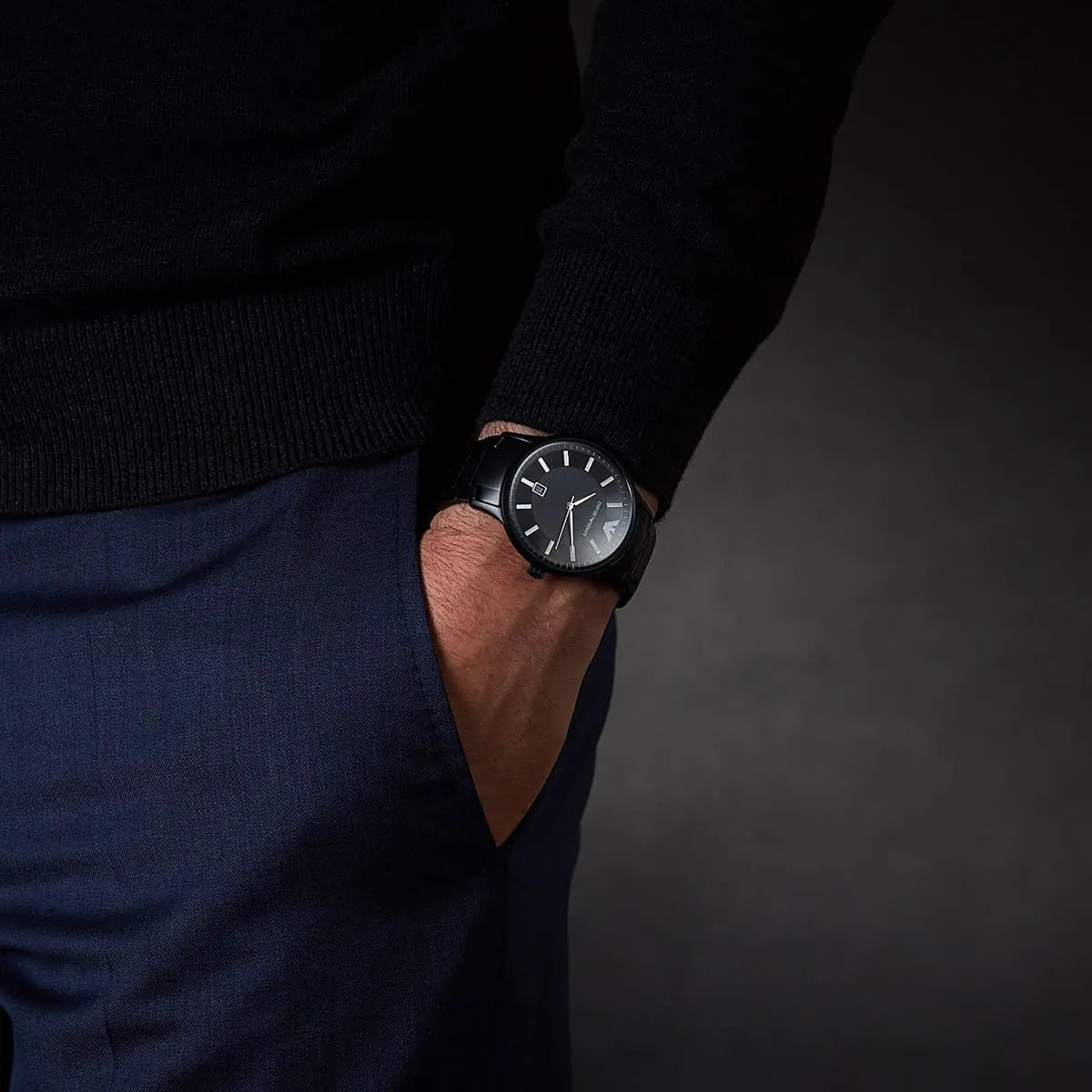 Emporio Armani Renato watch on wrist showing black dial and metal strap in natural light