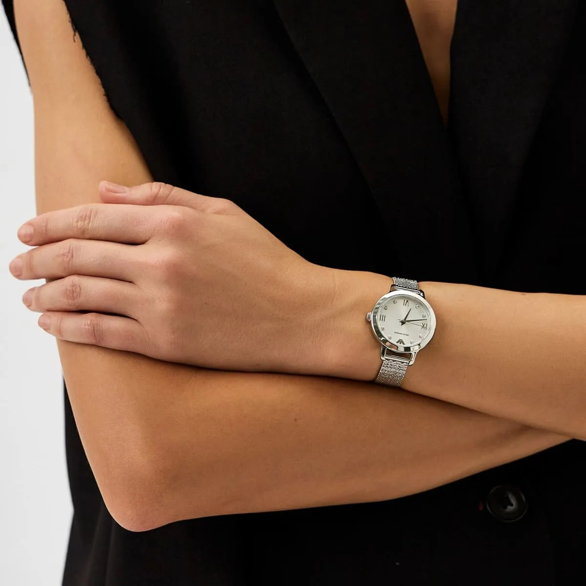 Emporio Armani AR11584 women's watch on wrist with silver dial and mesh band visible