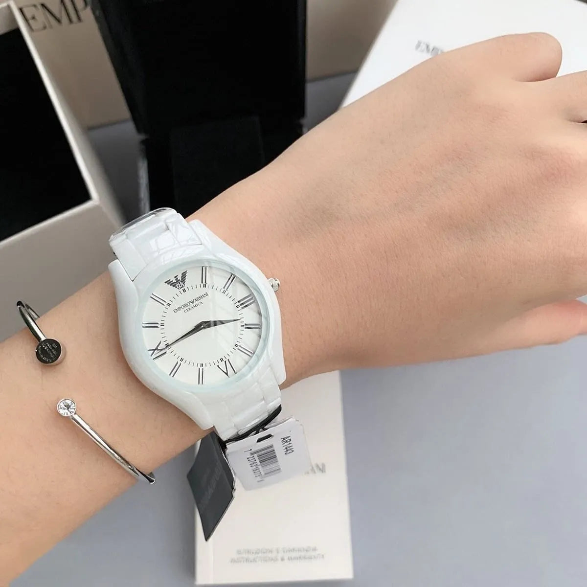 AR1443 Emporio Armani ceramic watch worn on wrist with white dial and ceramic bracelet