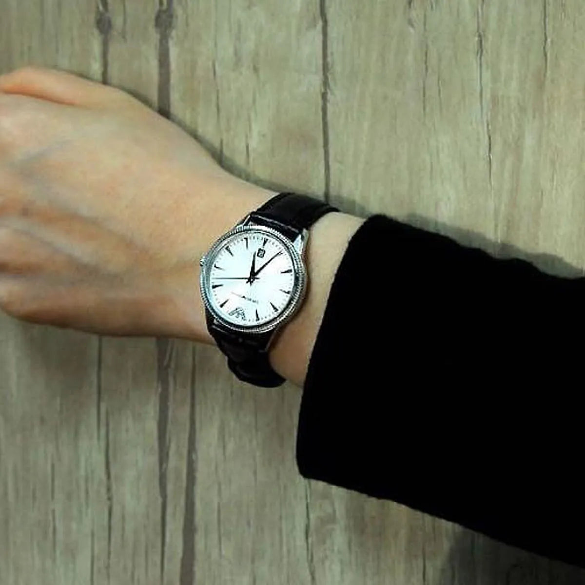 Emporio Armani AR2443 watch on wrist showing silver dial and black strap
