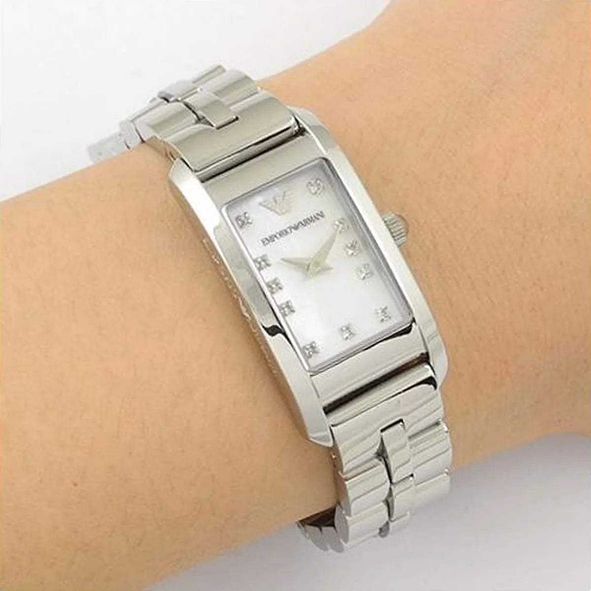 Emporio Armani AR3167 watch worn on wrist showing mother-of-pearl dial with diamonds
