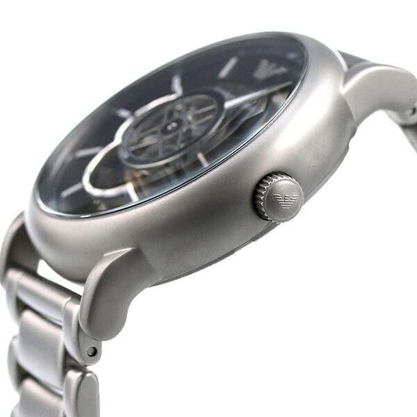 Side view of Emporio Armani AR60021 watch showing silver case, crown, and metal bracelet