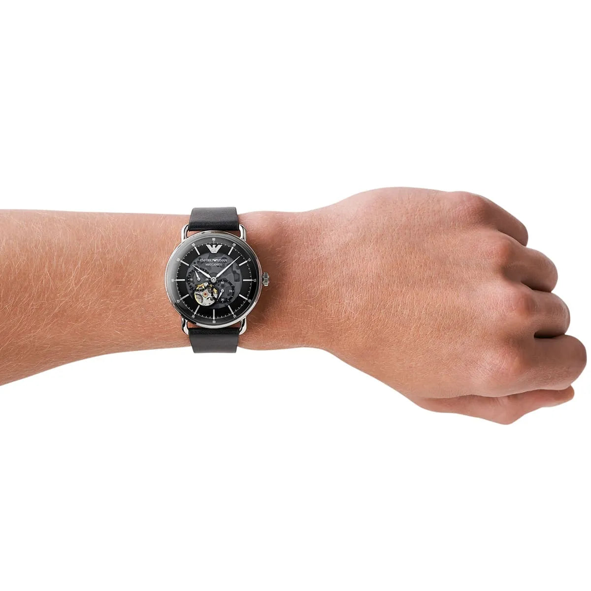 Emporio Armani Meccanico skeleton watch worn on wrist with black leather strap