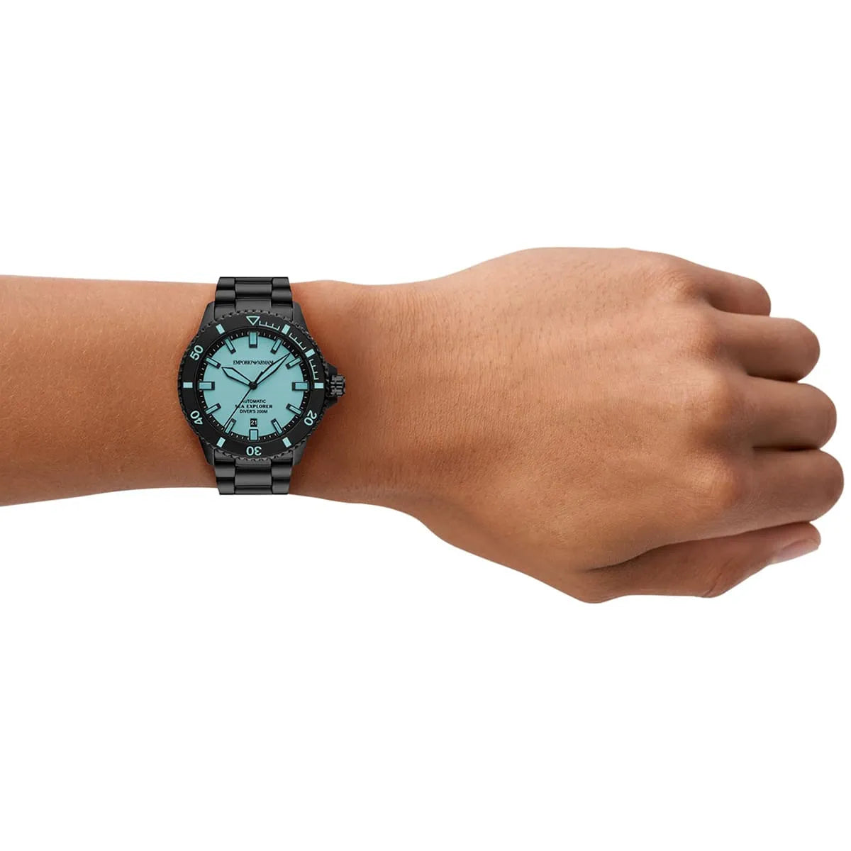 Emporio Armani Sea Explorer automatic watch worn on wrist, showing turquoise dial and black bracelet
