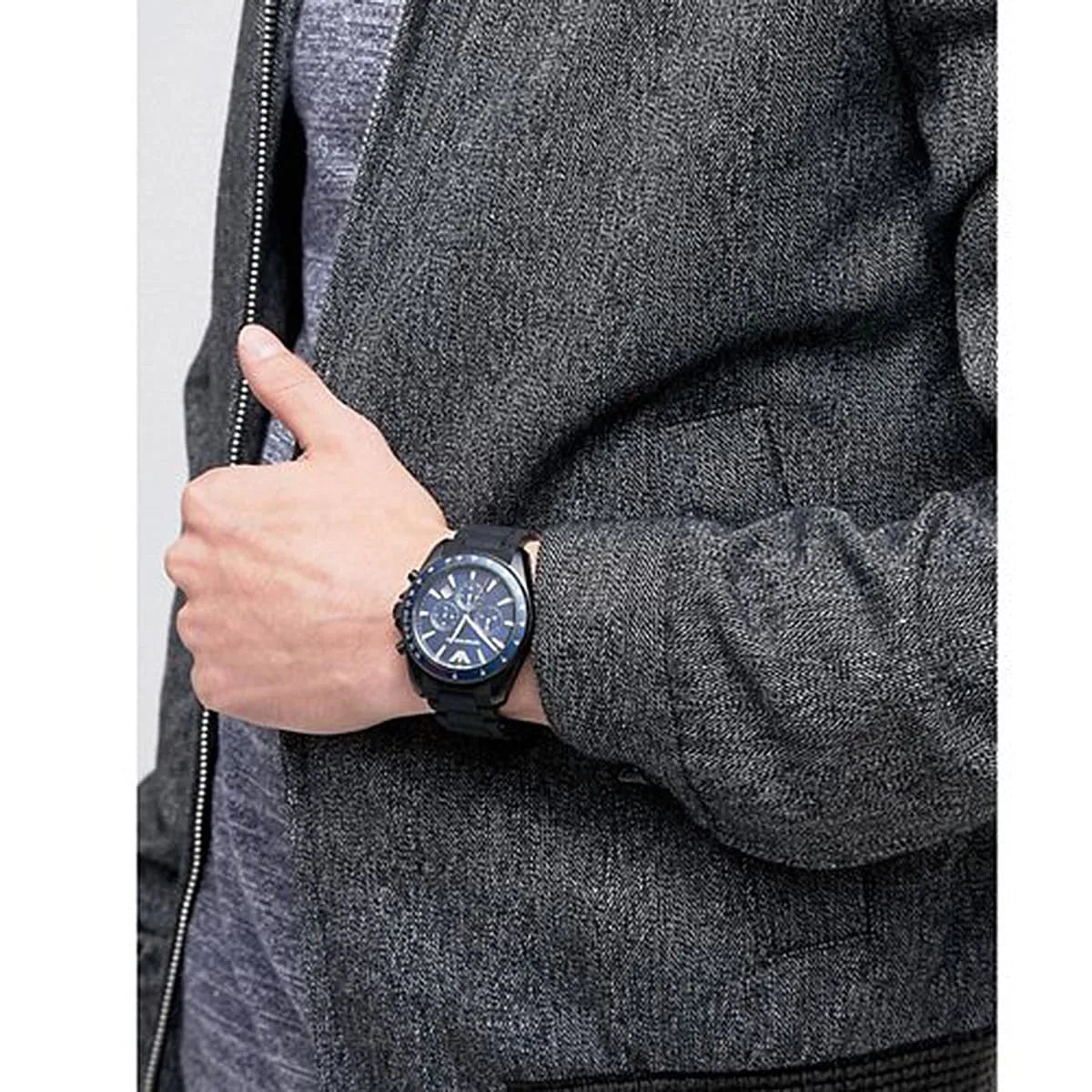 Sigma watch on wrist with blue dial chronograph visible on grey fabric background