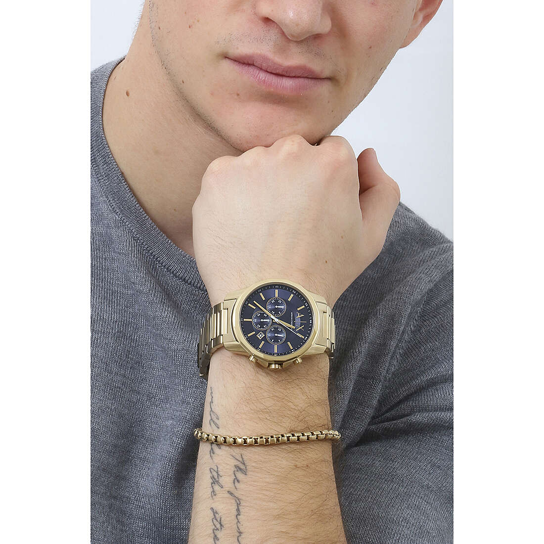 Armani Exchange Banks chronograph watch worn on wrist with gold case and blue dial