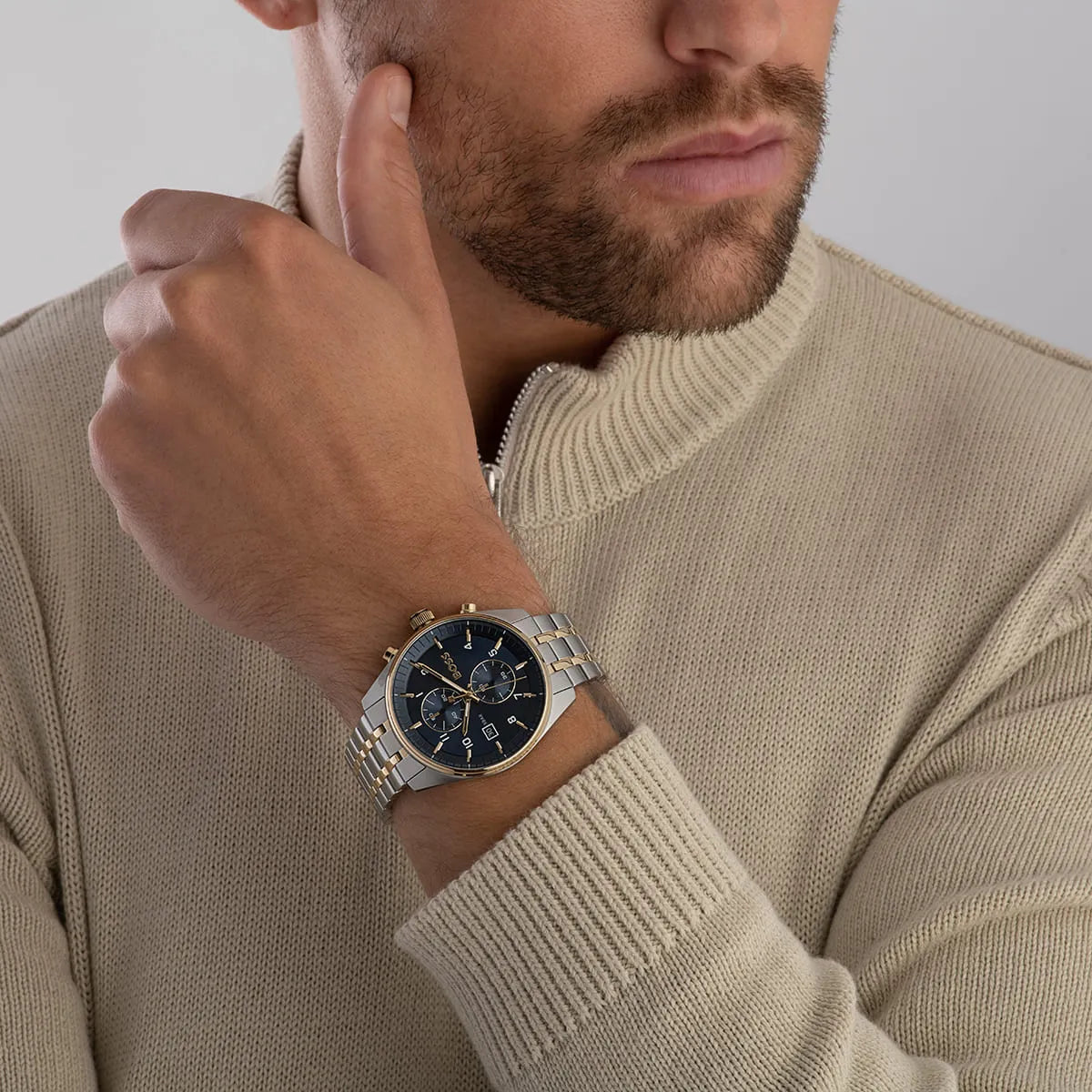 Hugo BOSS Skytraveller watch on wrist with beige sweater showing two-tone design