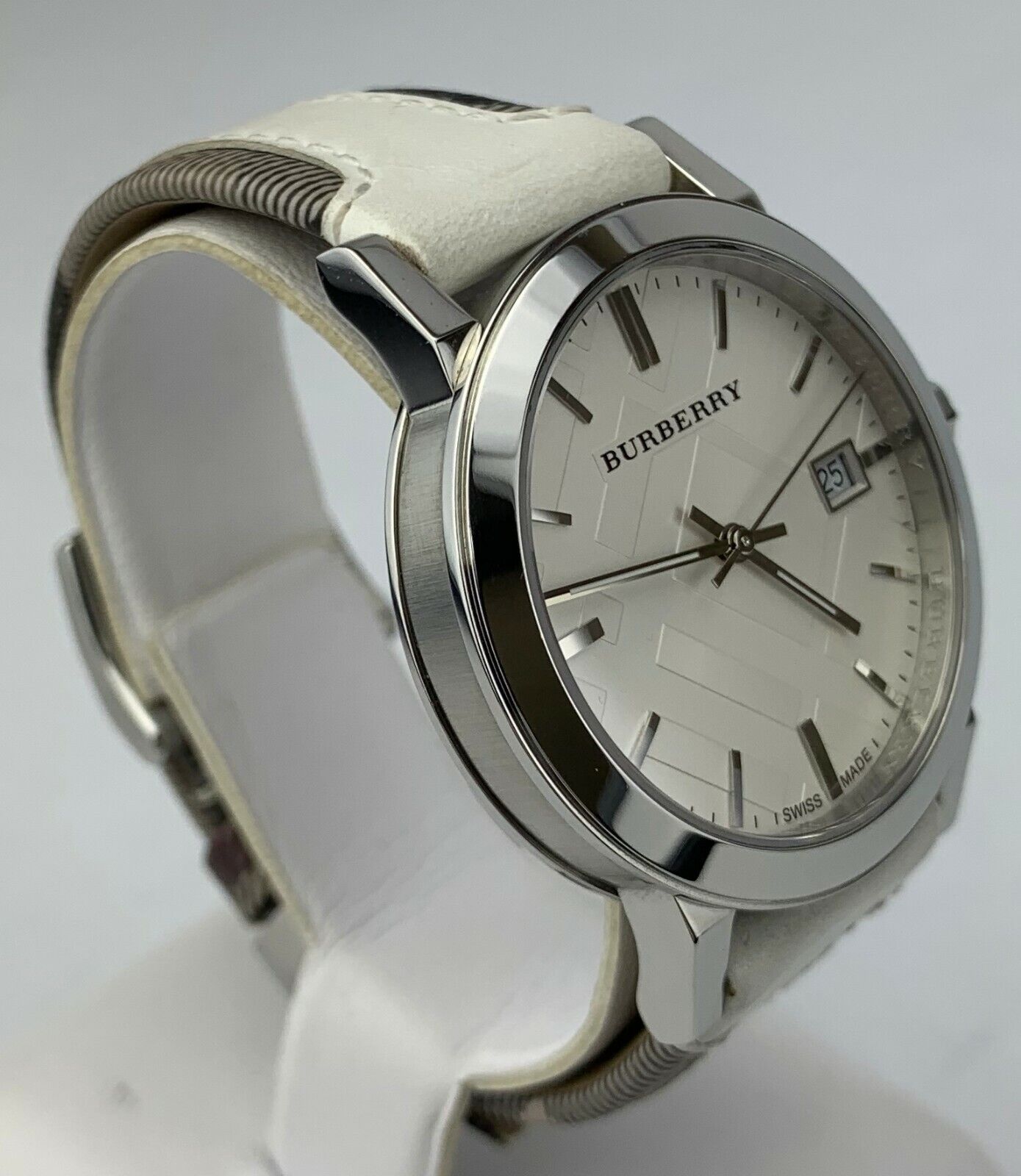 Burberry BU9019 watch angled view showing stainless steel case and white trench check leather strap