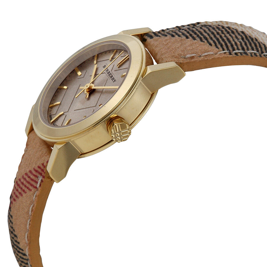 Side angle view of Burberry ladies watch showing champagne dial and patterned fabric strap