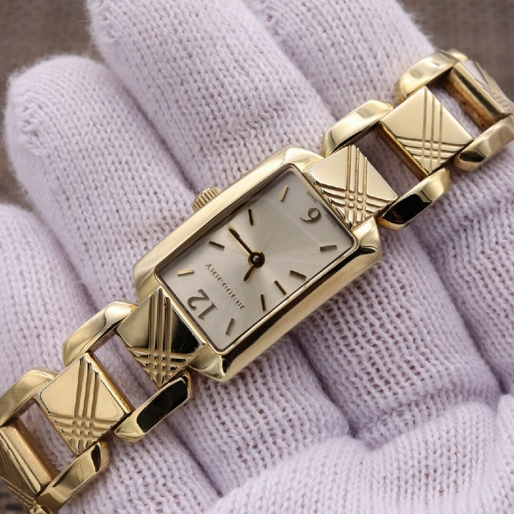 Burberry Heritage BU4213 silver dial and gold bracelet detail on white fabric