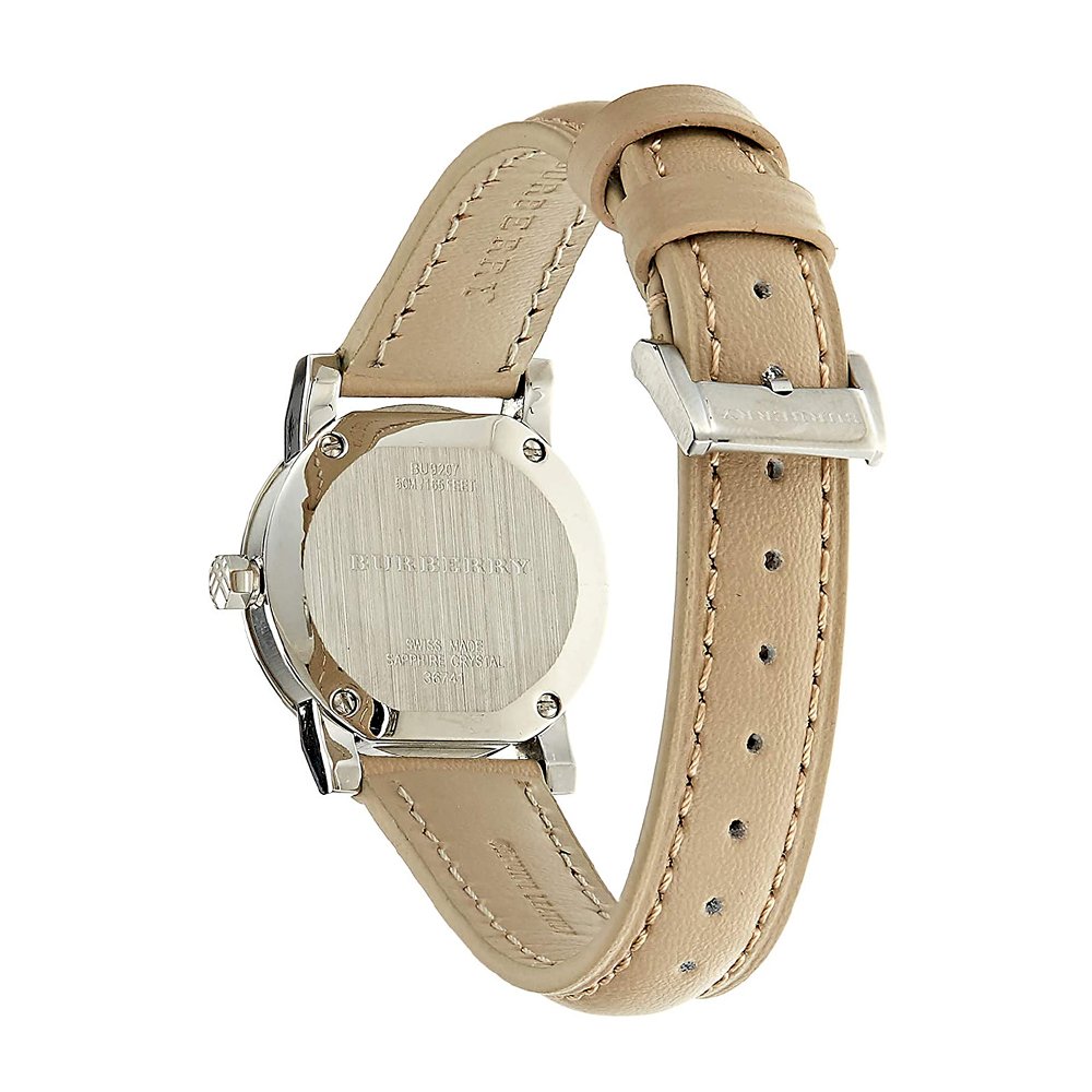 Burberry The City watch caseback showing engraved branding and beige leather strap