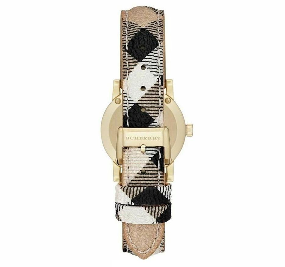 Back view of Burberry The City watch showing gold-tone case back with engraved logo