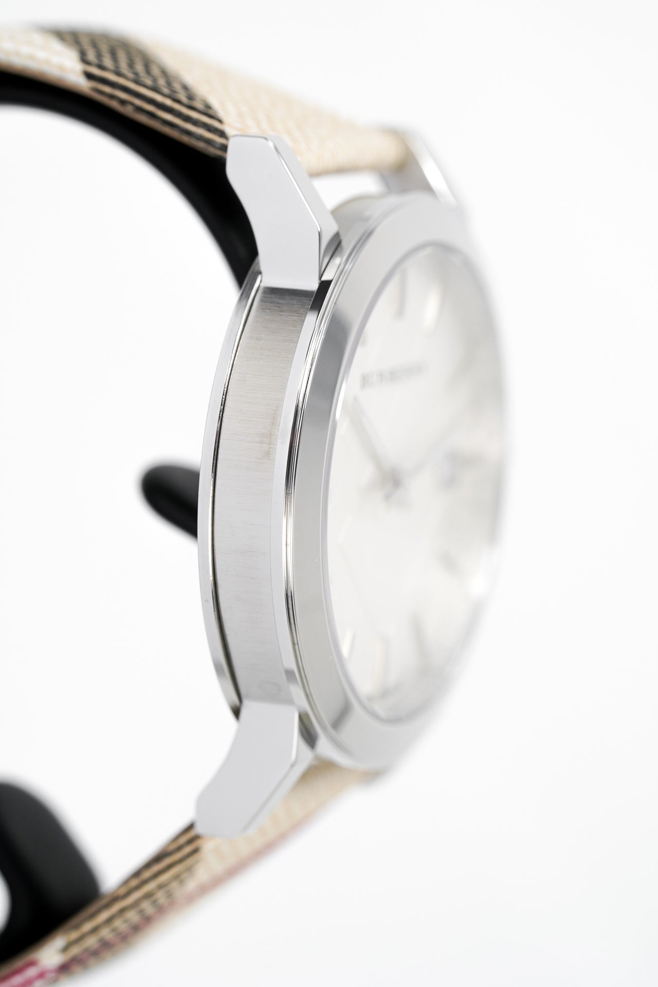 Side view of Burberry women's watch showing silver case profile and fabric strap