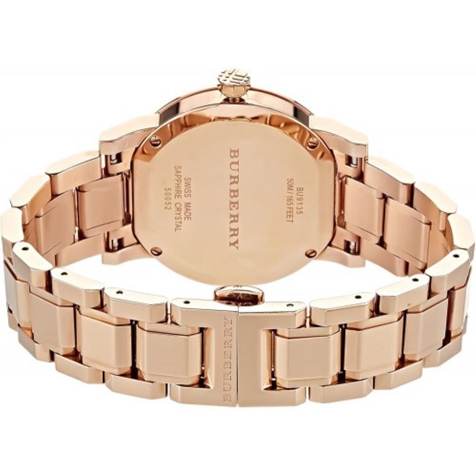 Caseback view of Burberry The City rose gold watch with engraved branding