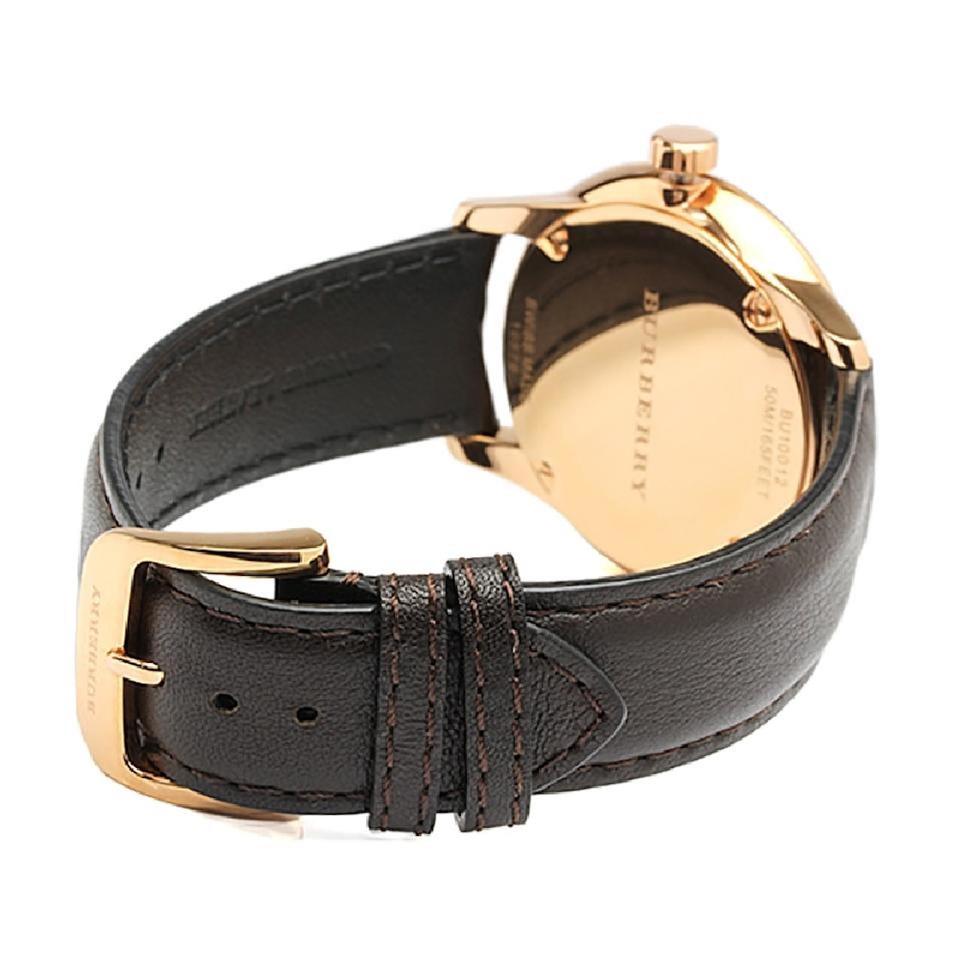Case back view of Burberry The Classic watch with rose gold-tone display caseback and black leather strap