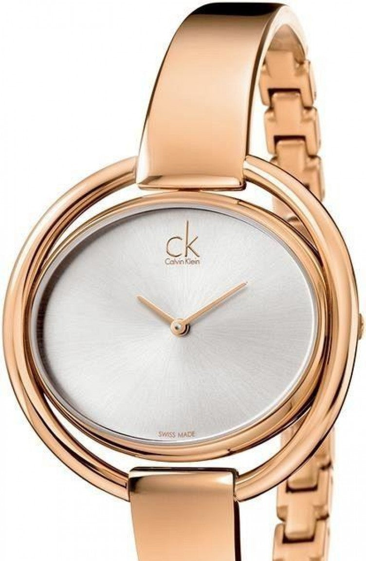 Calvin Klein Impetuous rose gold ladies watch worn on wrist with bangle bracelet