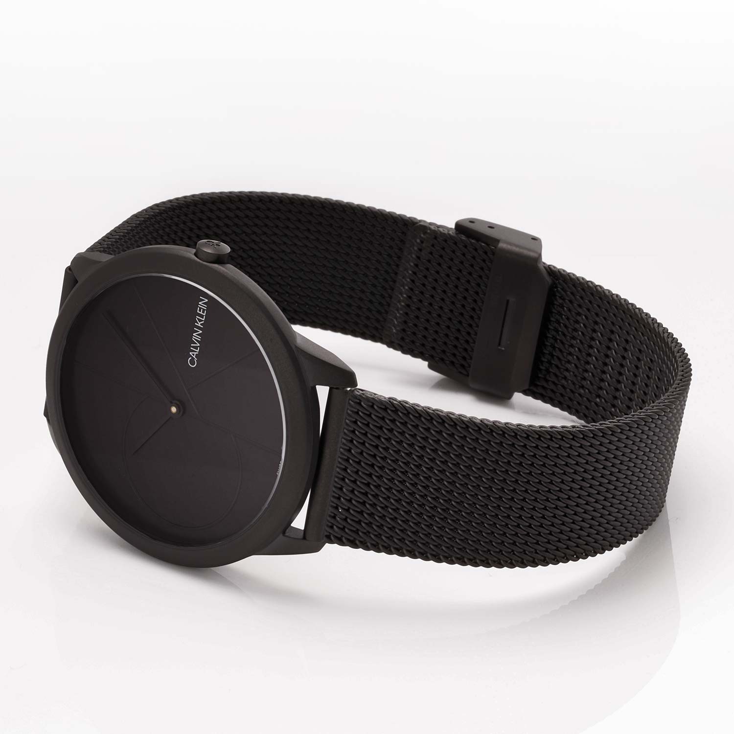 Full wrist view of minimalist black dial watch with mesh bracelet