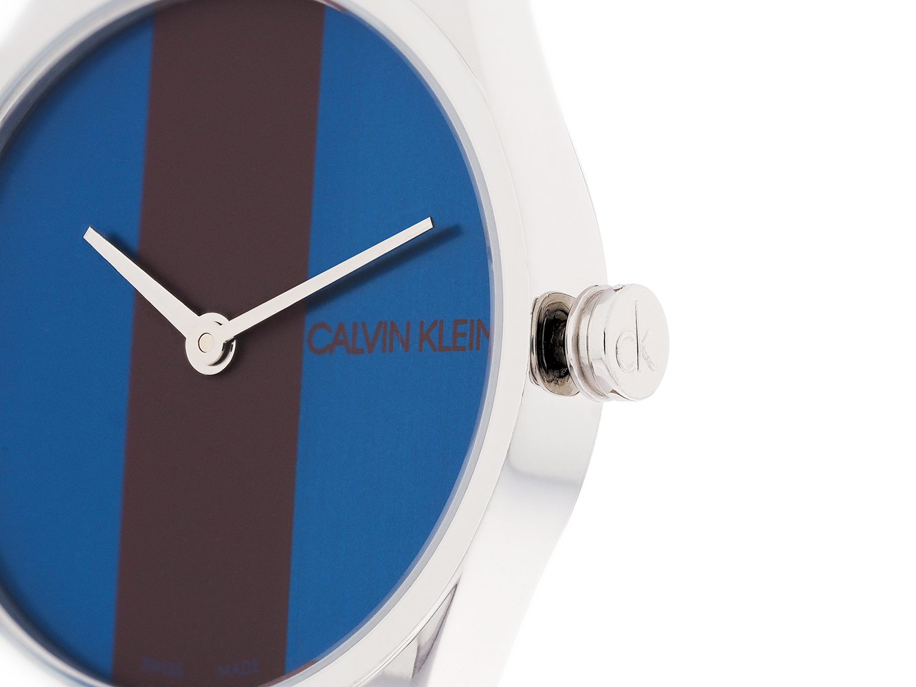 Close-up of Calvin Klein Rise K8P231UN dial showing blue background with burgundy vertical stripe and logo