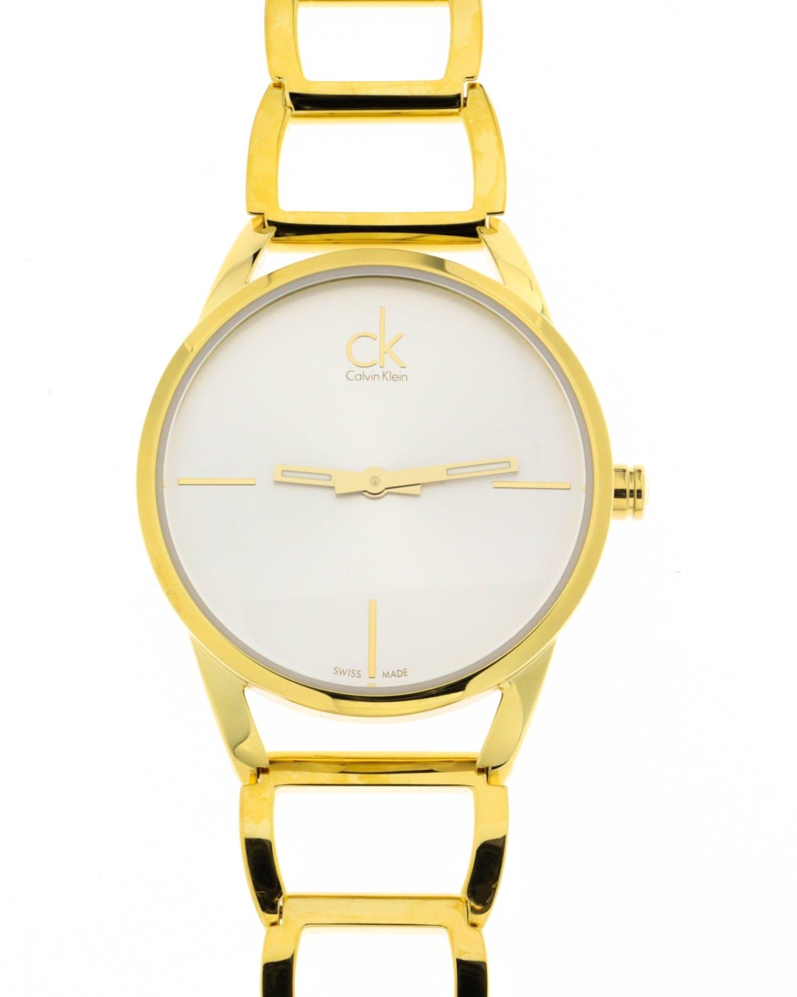 Calvin Klein Stately watch dial detail with minimalist silver face and gold hour markers