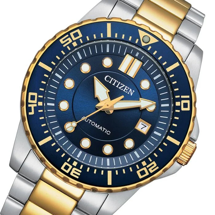 Close-up of blue dial with applied hour markers, date window, and gold-tone hands