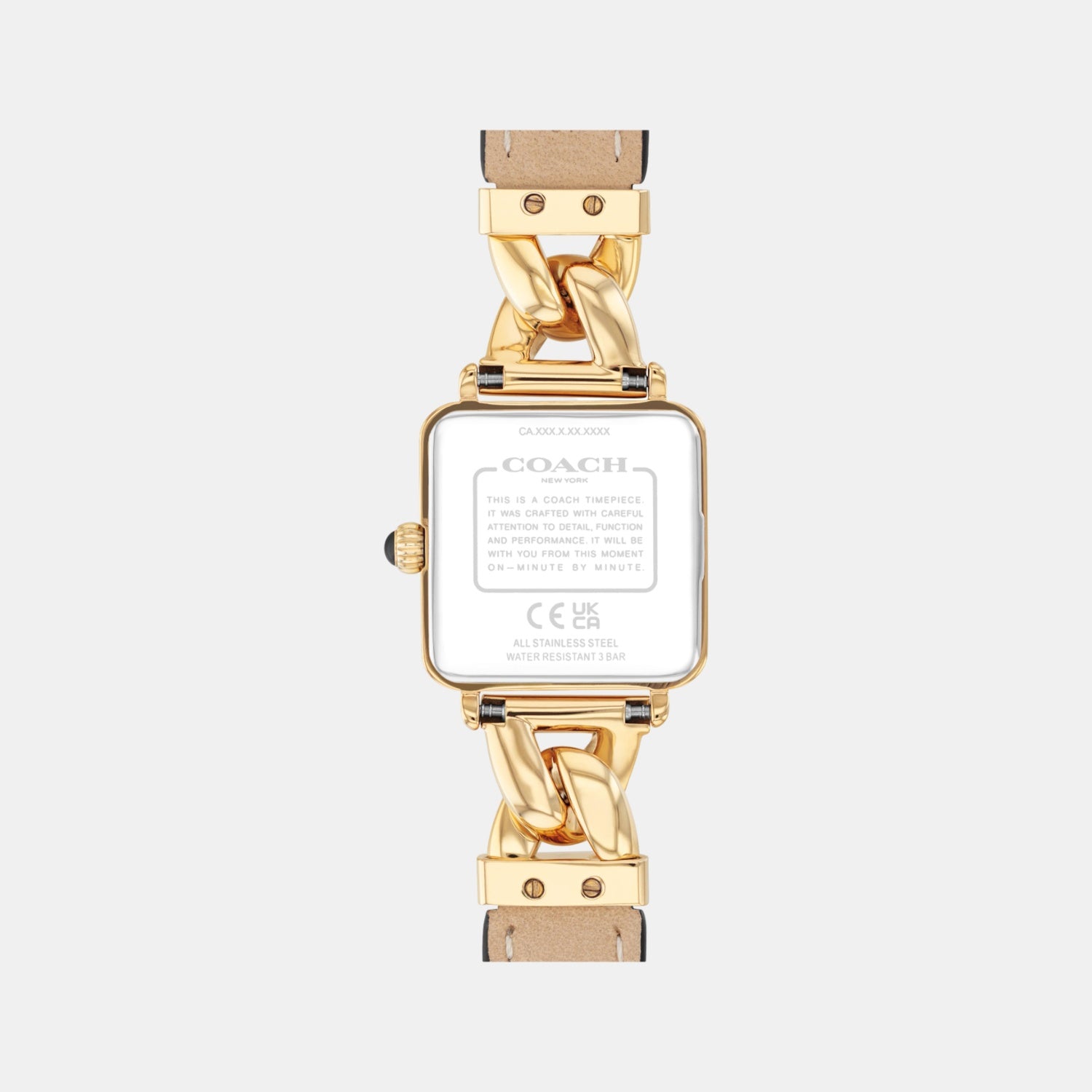 Caseback of Coach Cass watch displaying gold-tone case back with Coach branding and chain link connector