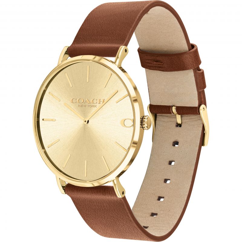 Coach Charles gold watch on wrist with brown leather strap detail