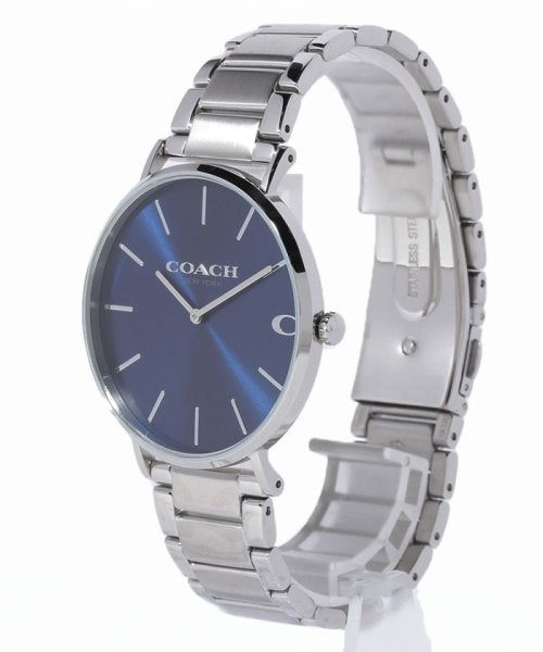 Coach Charles men's watch shown at angle with stainless steel bracelet and navy dial
