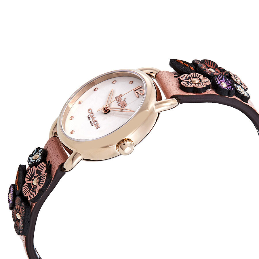 Coach Delancey watch angled view showing gold dial and pink leather strap with multicolor embroidered flowers