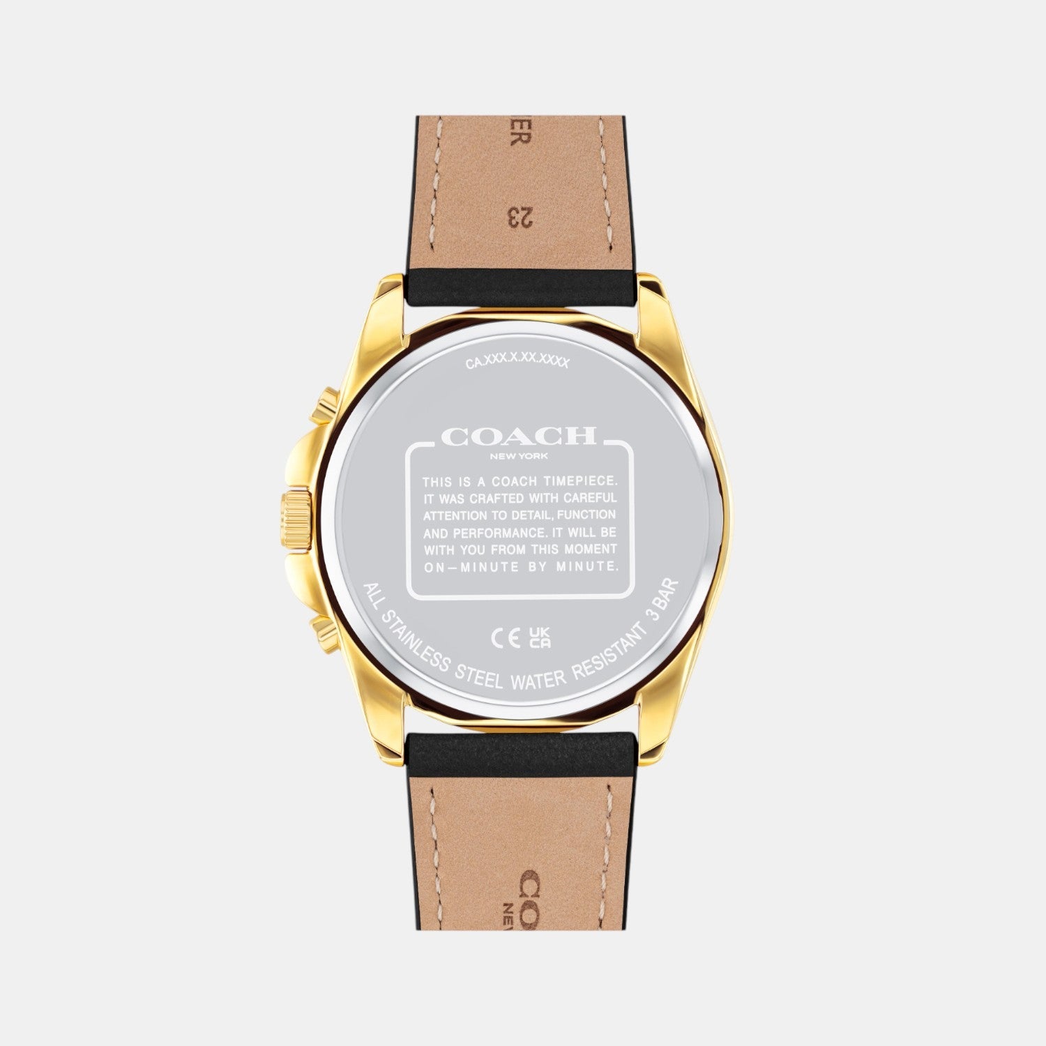COACH Greyson watch caseback showing gold-tone steel back with engraved COACH branding and specifications