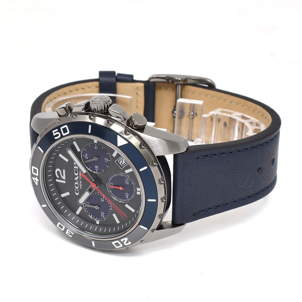 Coach Kent chronograph watch laying flat displaying full strap, stainless steel case with chronograph pushers, and navy leather band