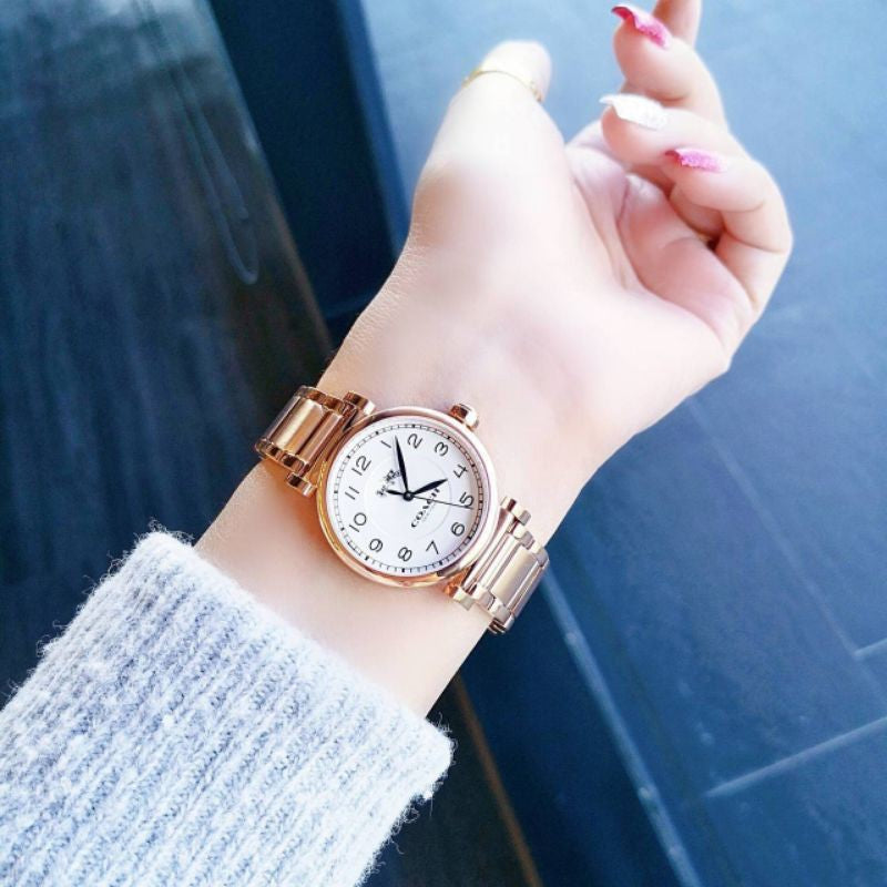 Coach Madison rose gold women's watch worn on wrist showing dial and bracelet