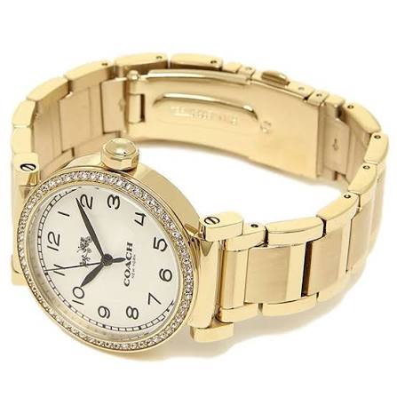 Coach Madison watch on wrist displaying gold-tone bracelet and white dial