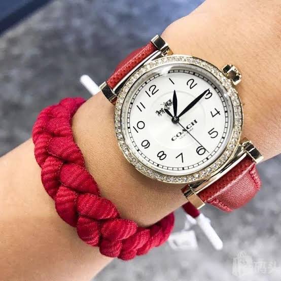 Coach Madison ladies watch worn on wrist showing white dial and red leather strap design