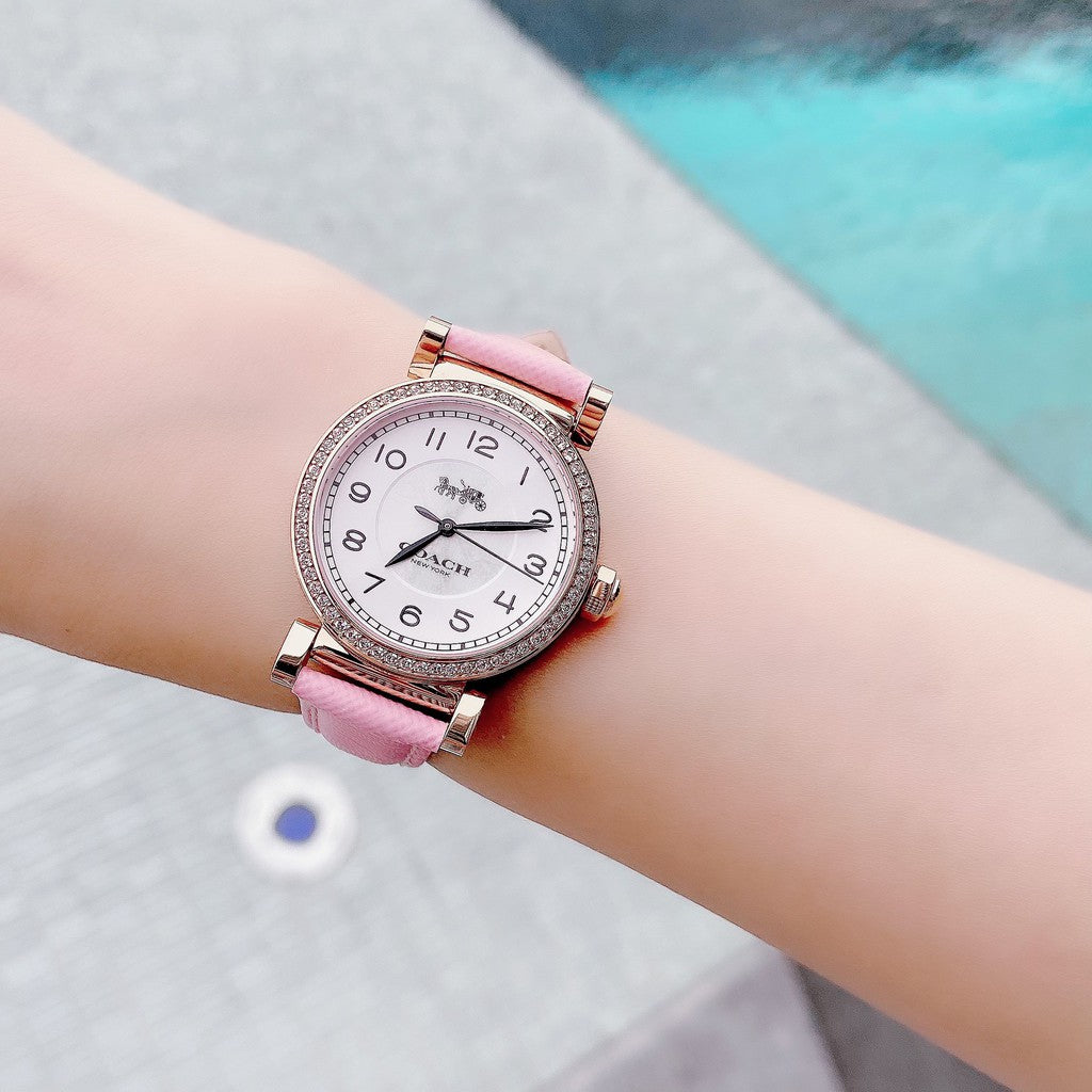 Coach Madison watch on wrist displaying rose gold case and pink leather band