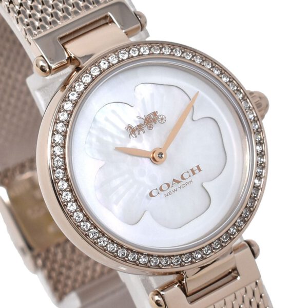 Close-up of mother of pearl dial with Coach logo and rose gold hands